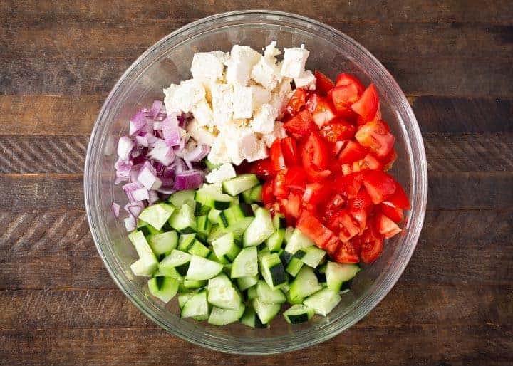 Cucumber Tomato Feta Salad ingredients in a glass bowl