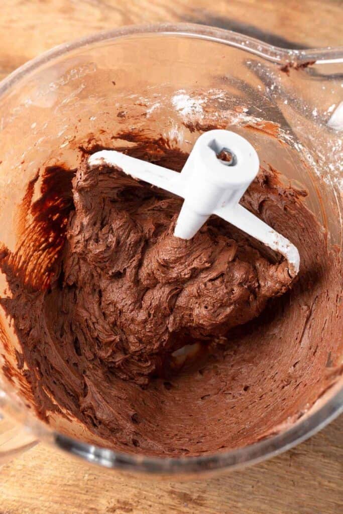 Chocolate Frosting in a glass bowl with the paddle