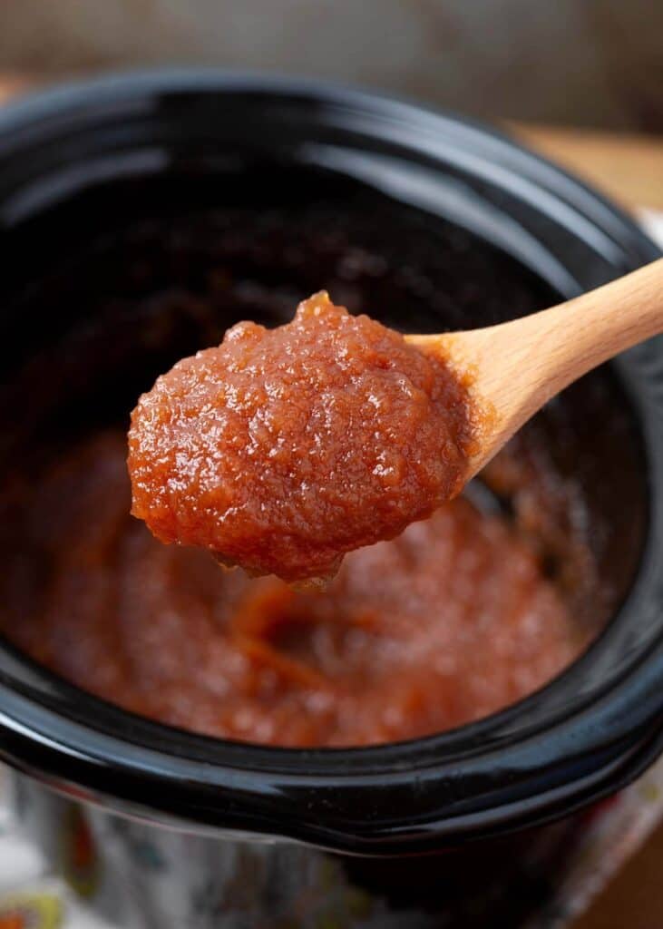 Slow Cooker Applesauce Apple Butter on a wood spoon