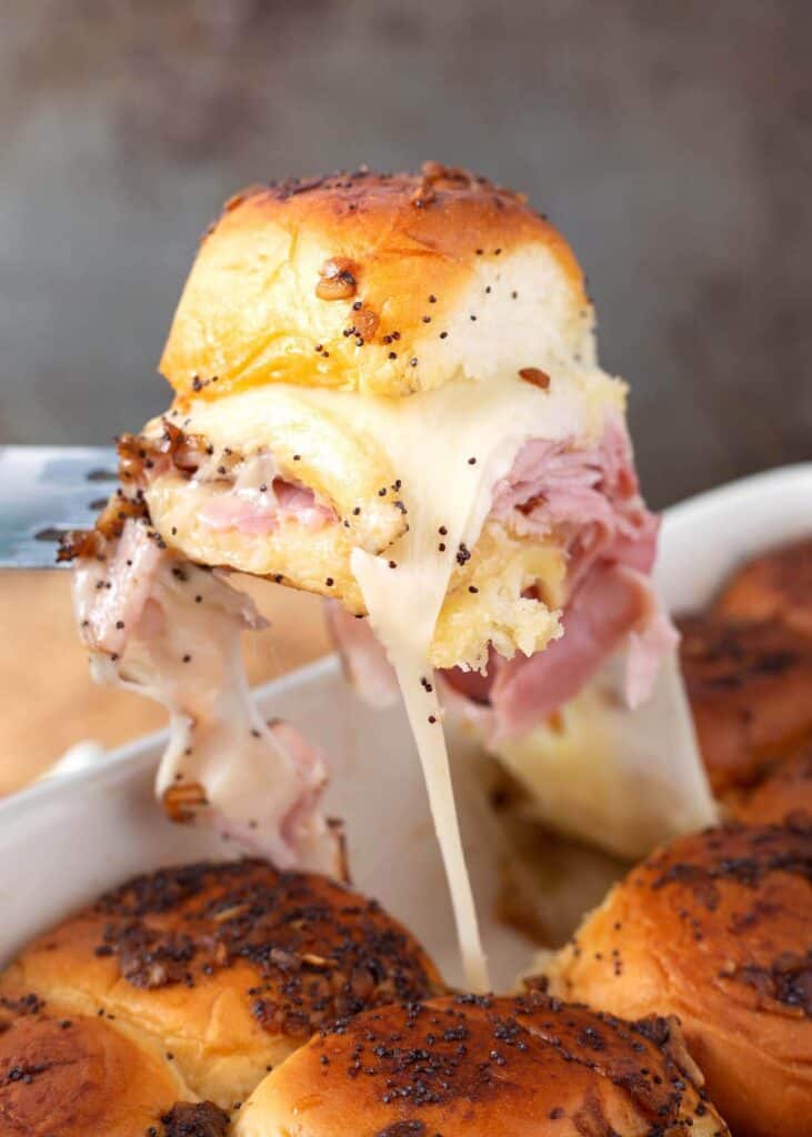 a Ham and Cheese Slider on a spatula lifting out of the pan