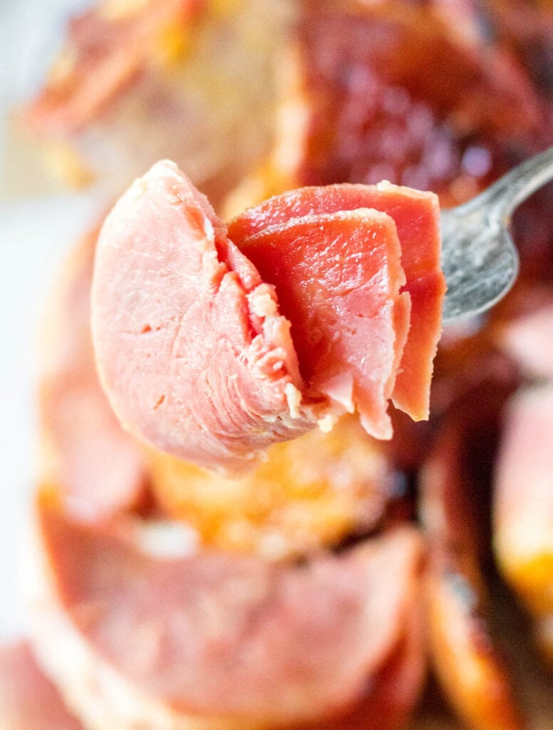 close up of a forkful of slow cooker spiral ham with pineapple glaze