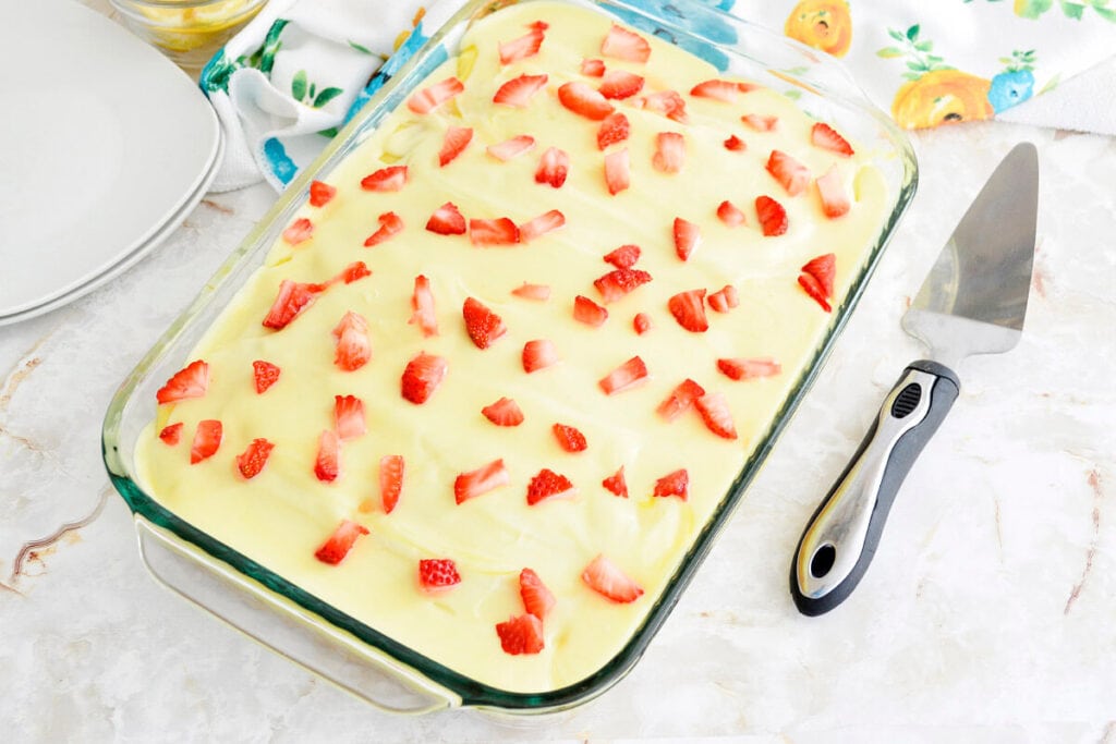 Whole Lemon Strawberry Poke Cake in a baking dish from above