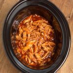 Slow Cooker BBQ Pulled Chicken in a black crock from above