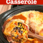Slow Cooker Enchilada Casserole on a spoon over a crock pot