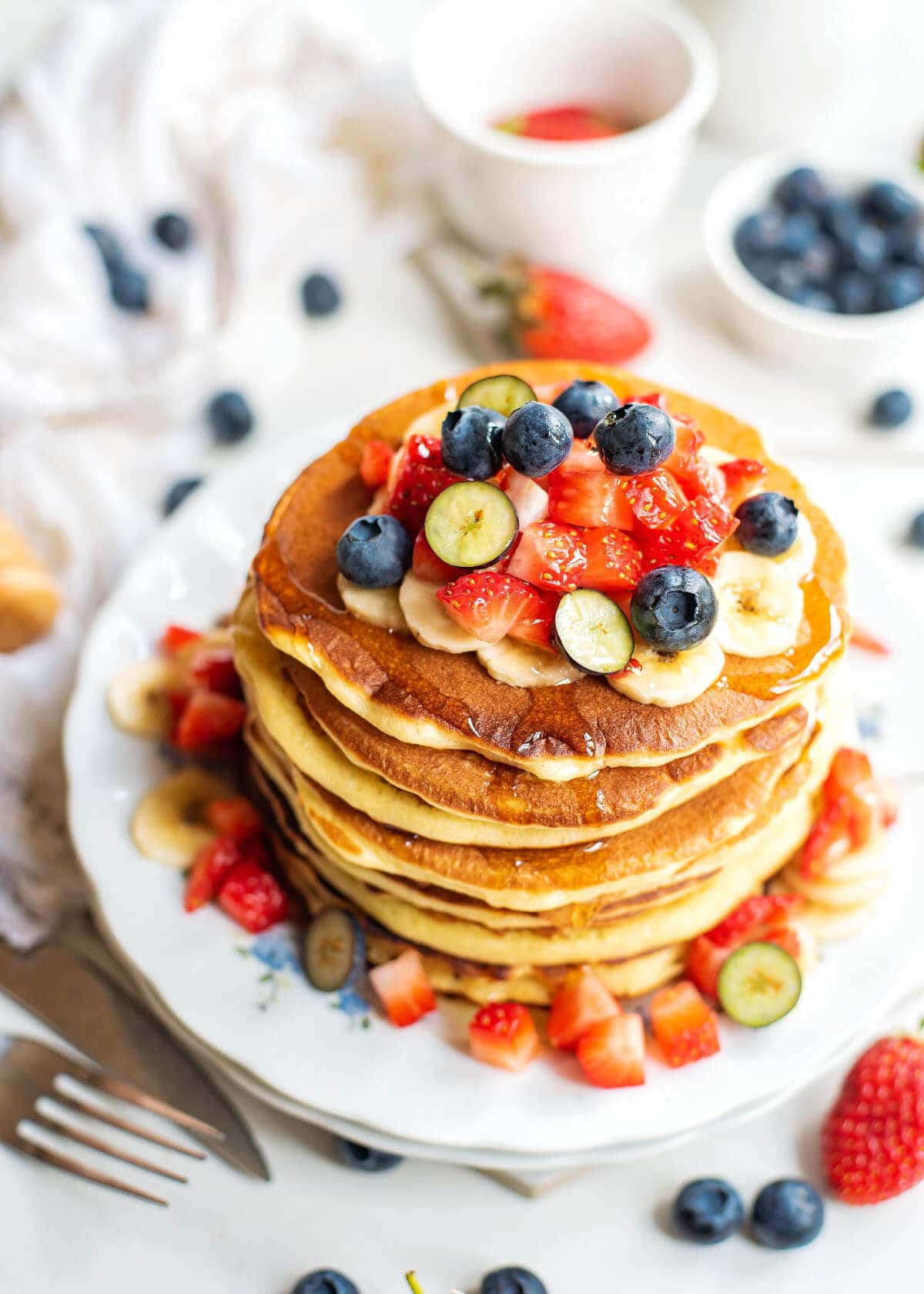 stack of hotcakes with fruit from above