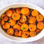 Maple Candied Sweet Potatoes in a white casserole dish