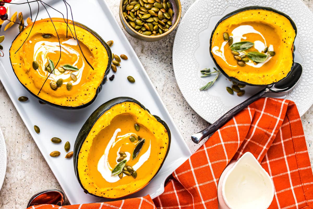 acorn squash artfully arranged with soup in them