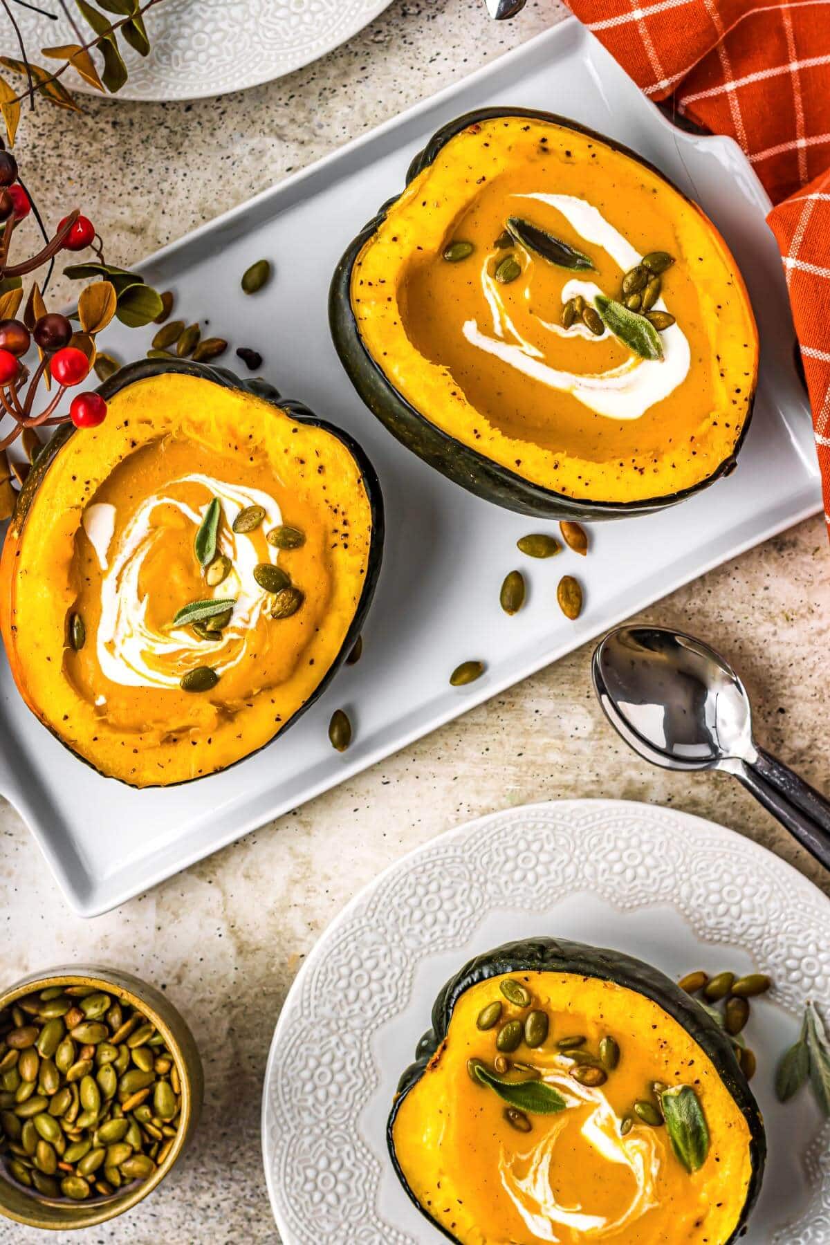 acorn squash artfully arranged with soup in them