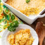 corn casserole on a white plate and in a square white baking dish
