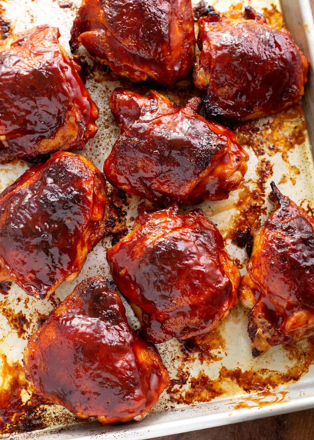 baked bbq chicken thighs on a baking sheet pan