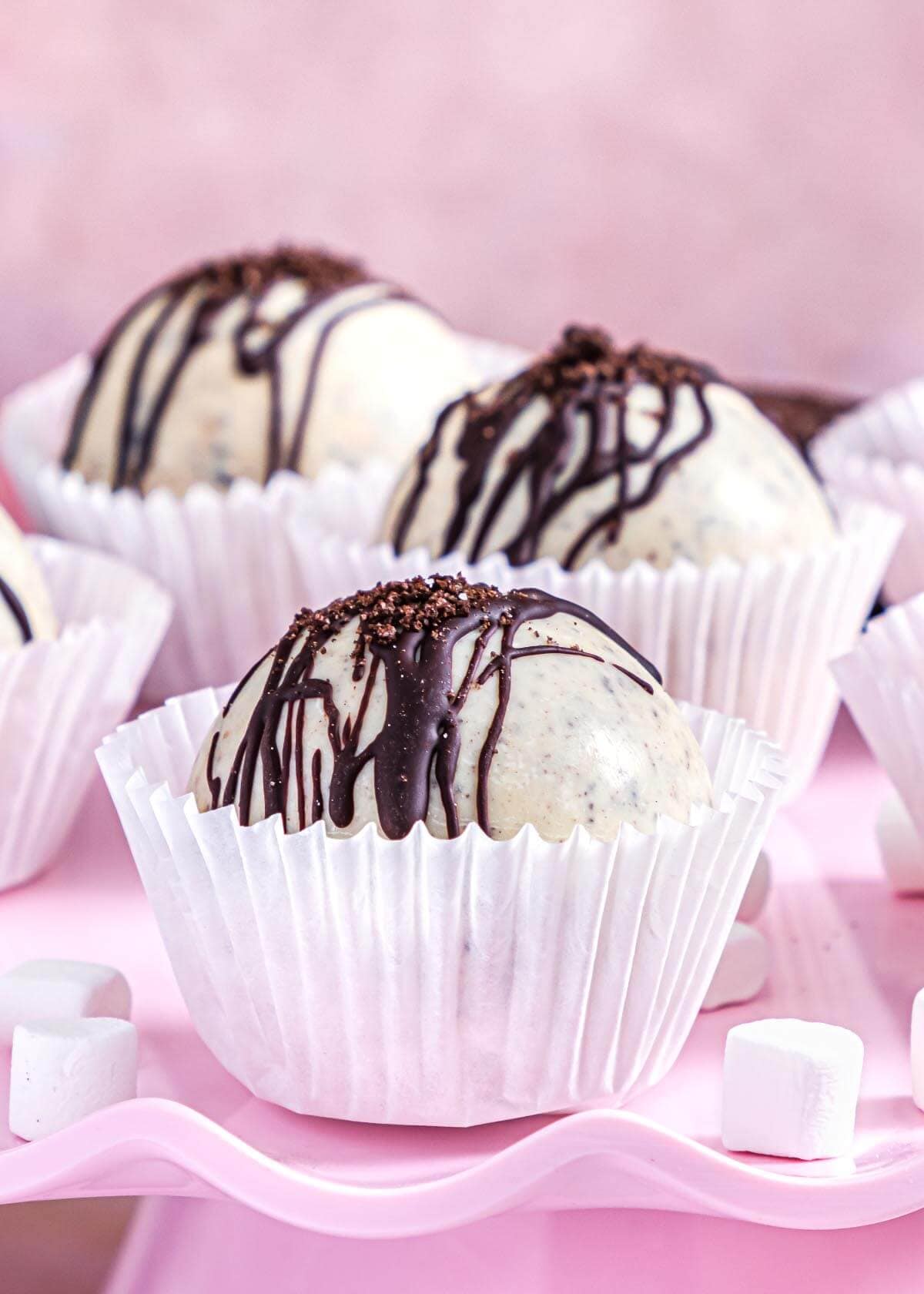 Cookies and Cream Hot Cocoa Bombs on pink background