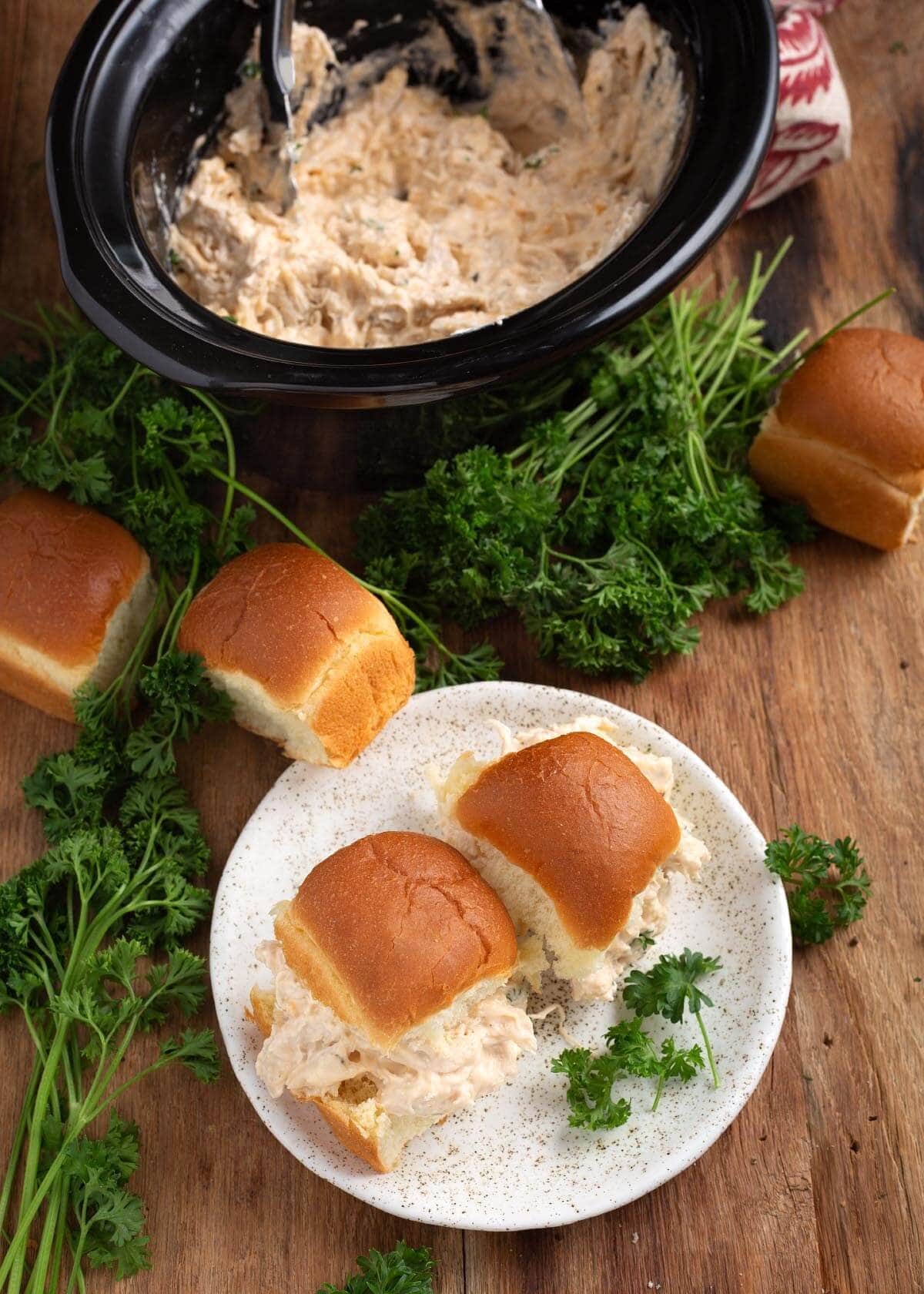 Slow Cooker Creamy Ranch Chicken in a crock and on 2 buns