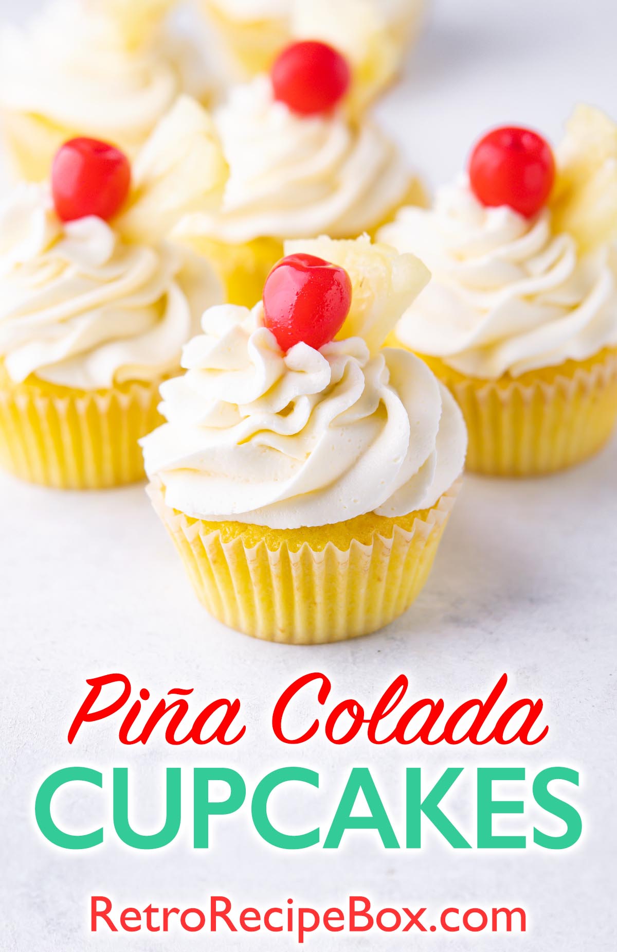 Piña Colada Cupcakes on light grey surface