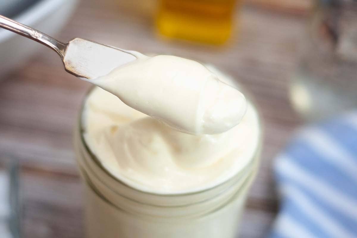 Mayonnaise in a jar with knife