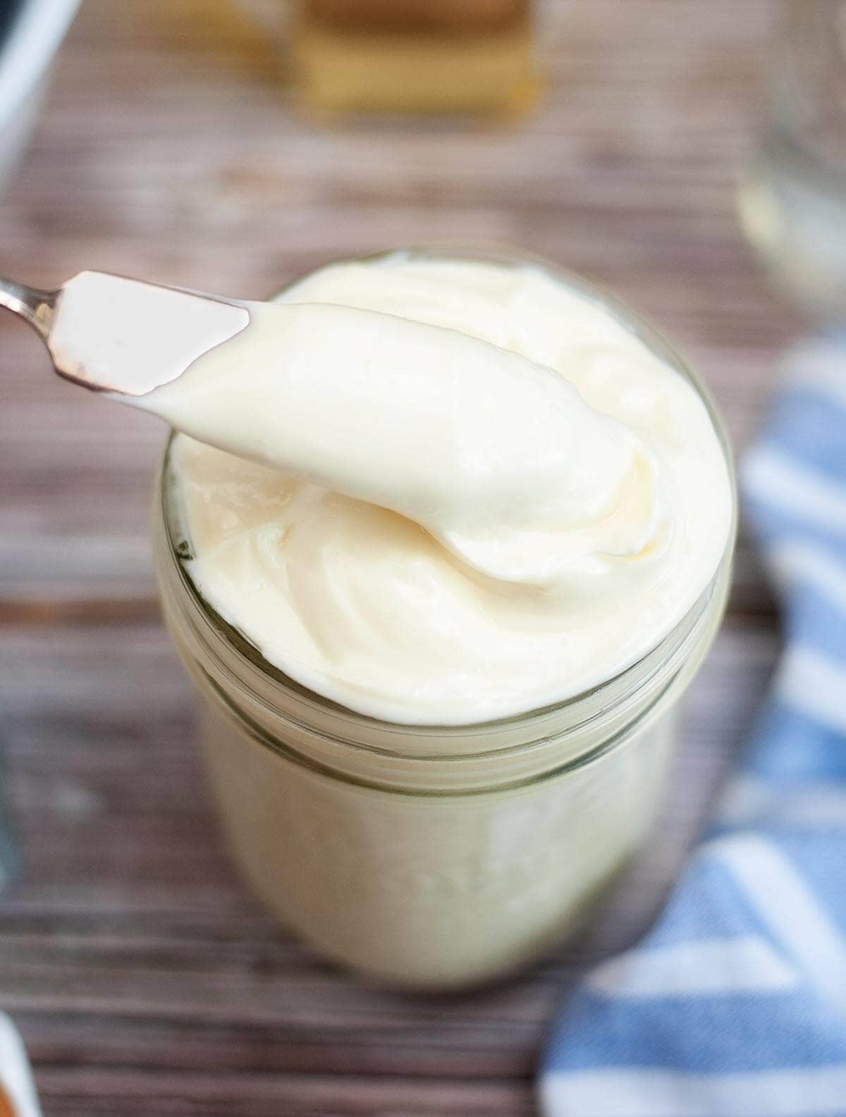Homemade Mayonnaise in a jar with knife