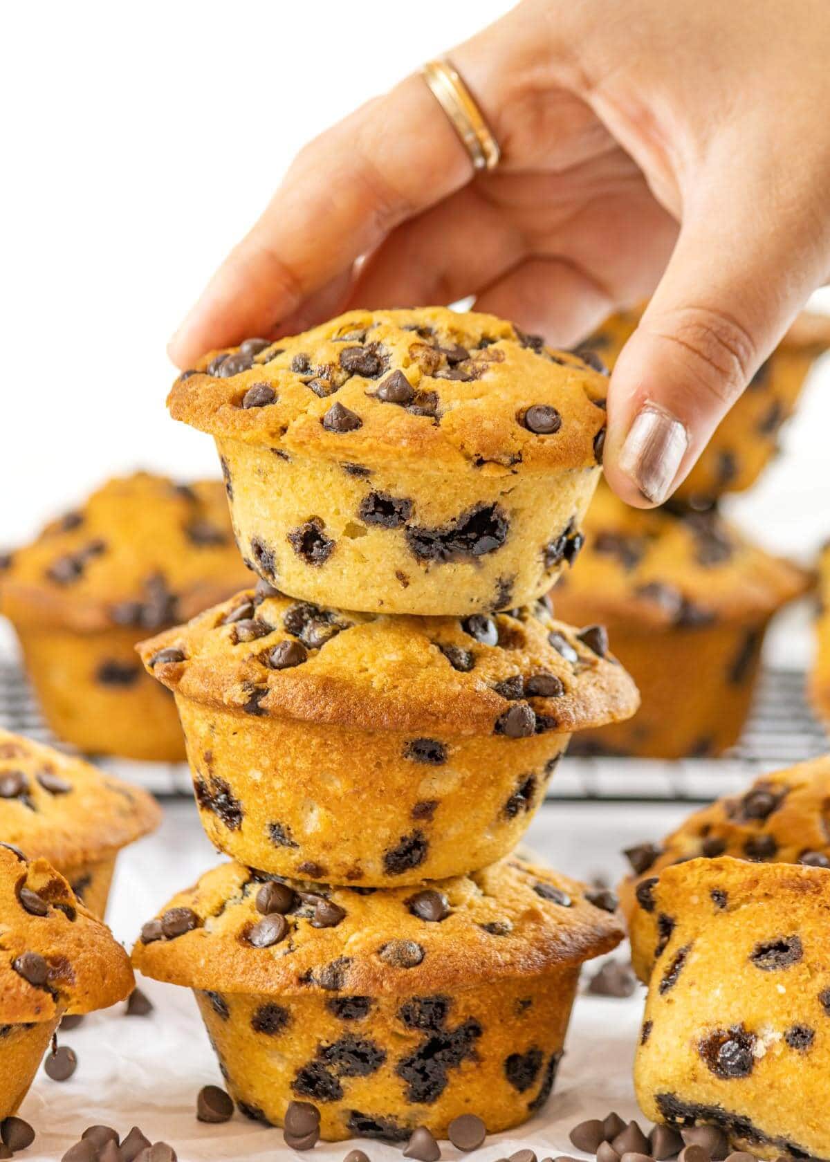 hand grasping at Chocolate Chip Muffins