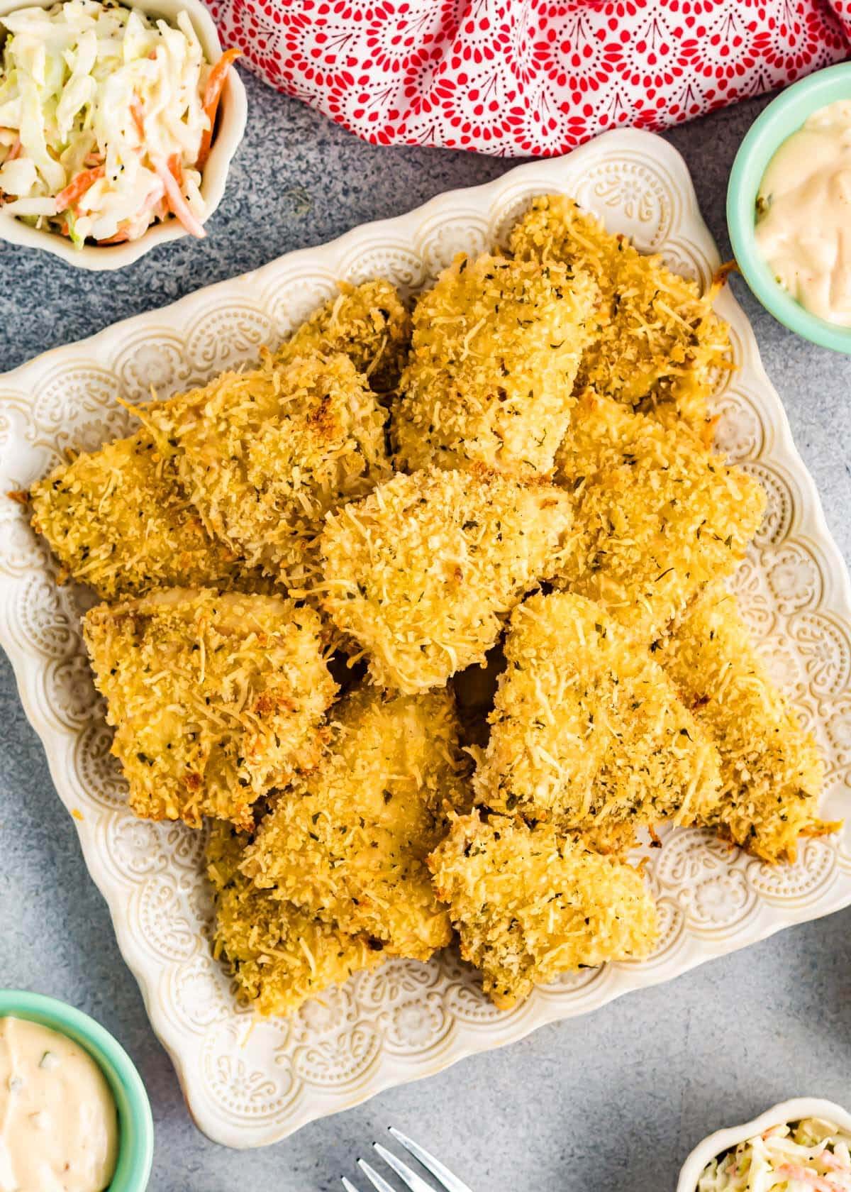 Baked Parmesan Crusted Fish pieces on a square plate