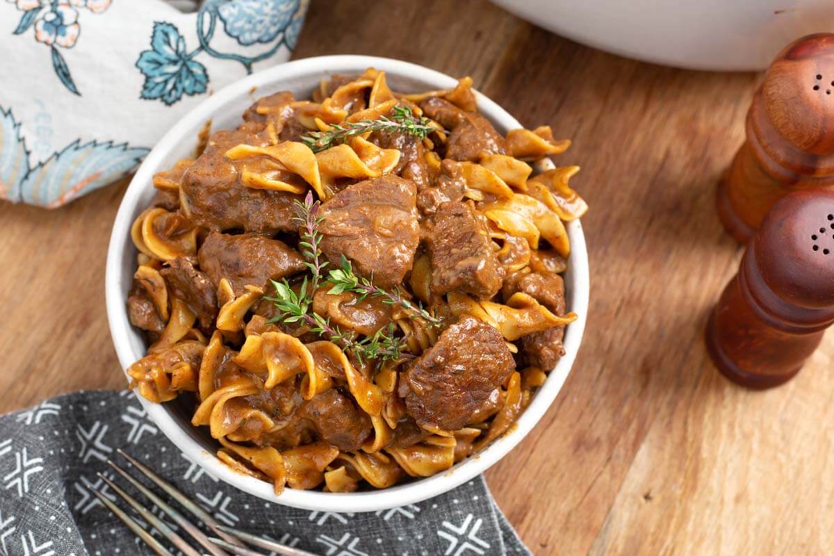 Beef and Noodles Recipe in a light bowl on wood