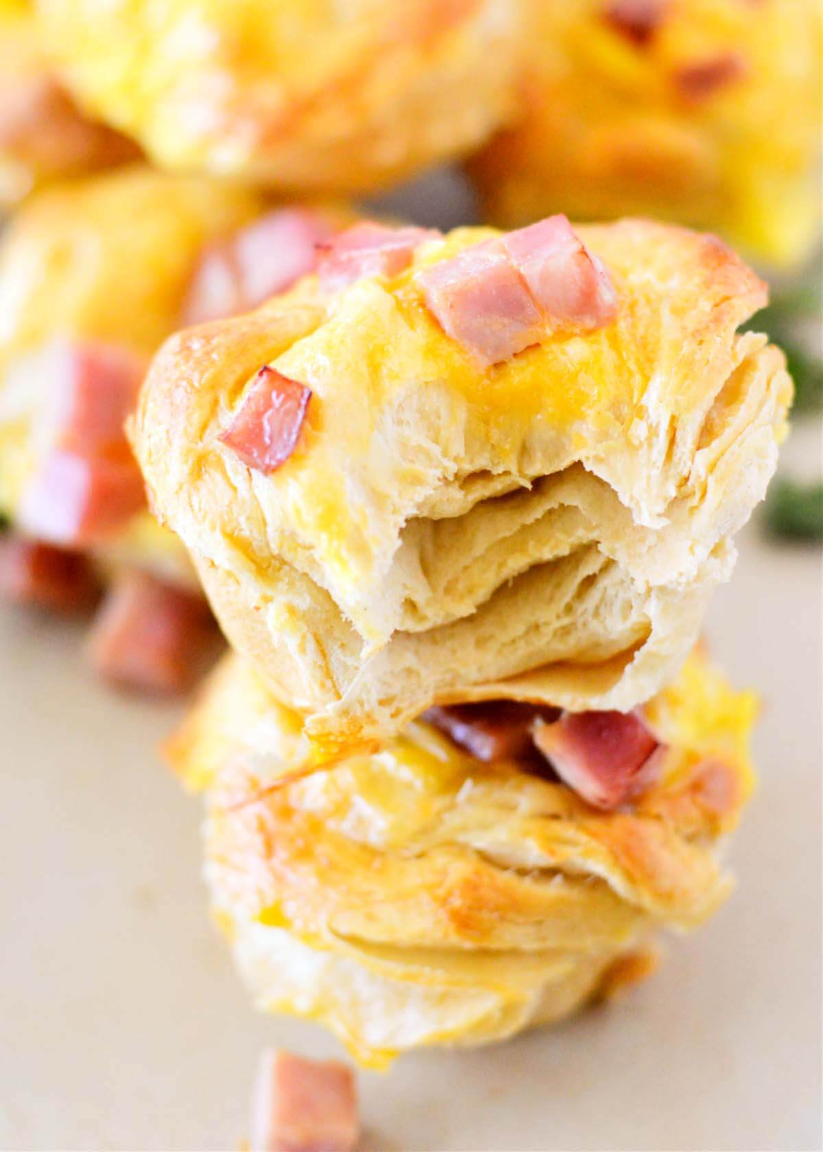 Cheesy Ham and Egg Biscuit Cups with bites in them