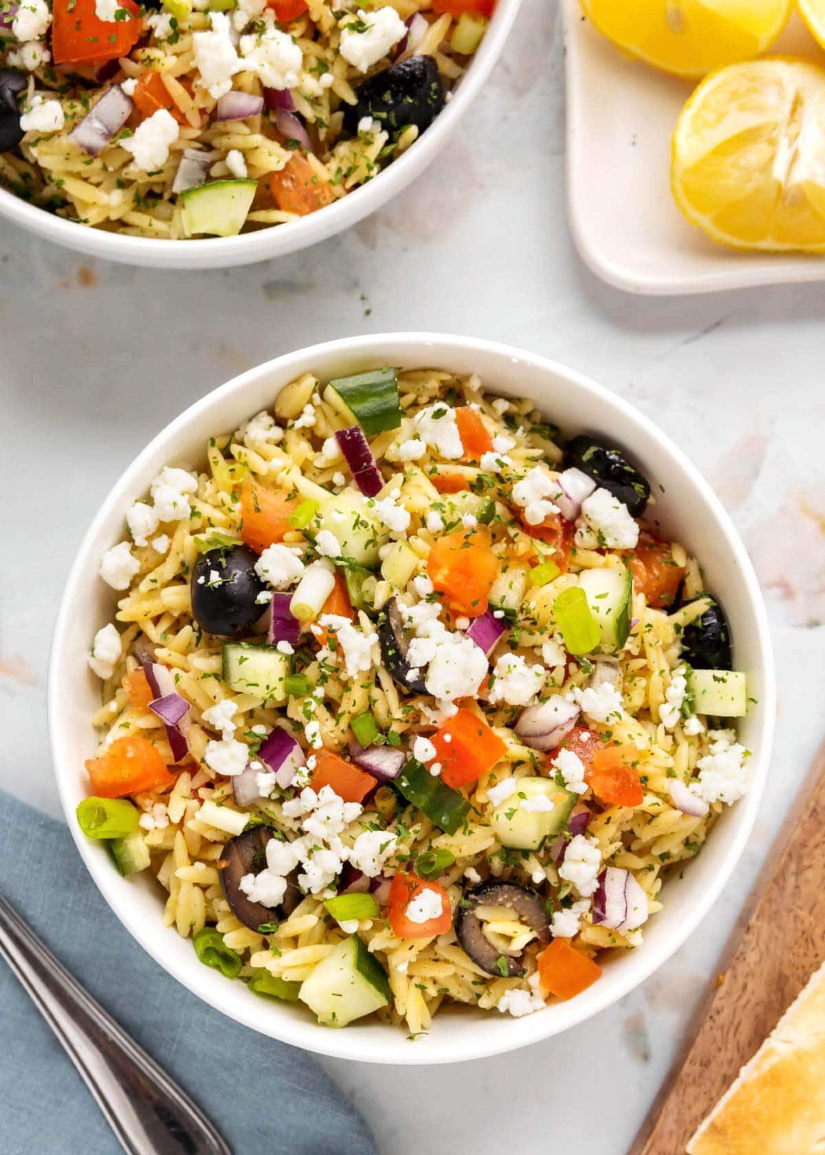 orzo salad in a white bowl