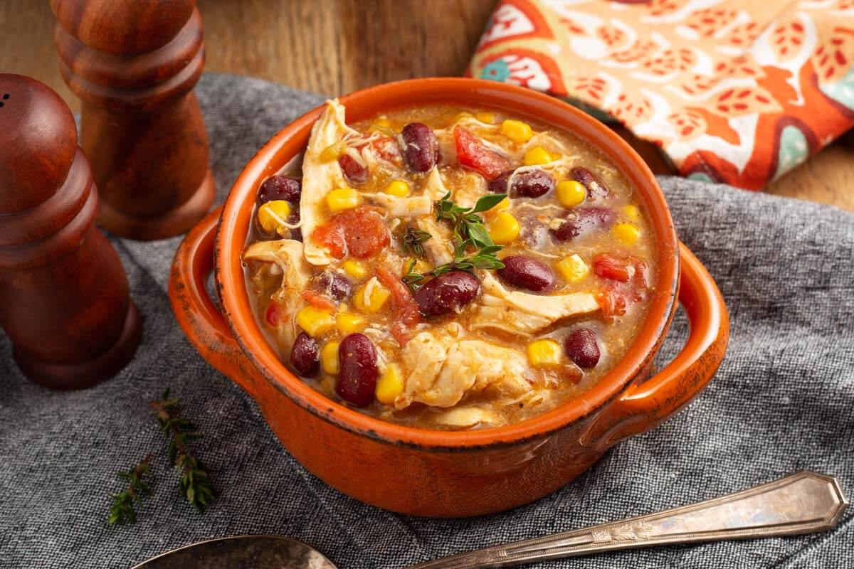 crock pot mexican Chicken Stew in a rust bowl