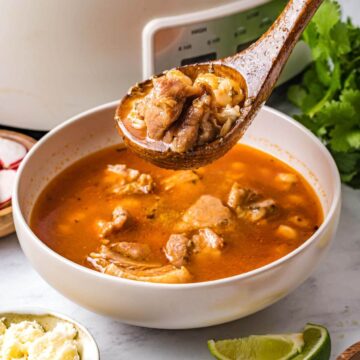 Slow Cooker Pozole in a bowl on a wood spoon