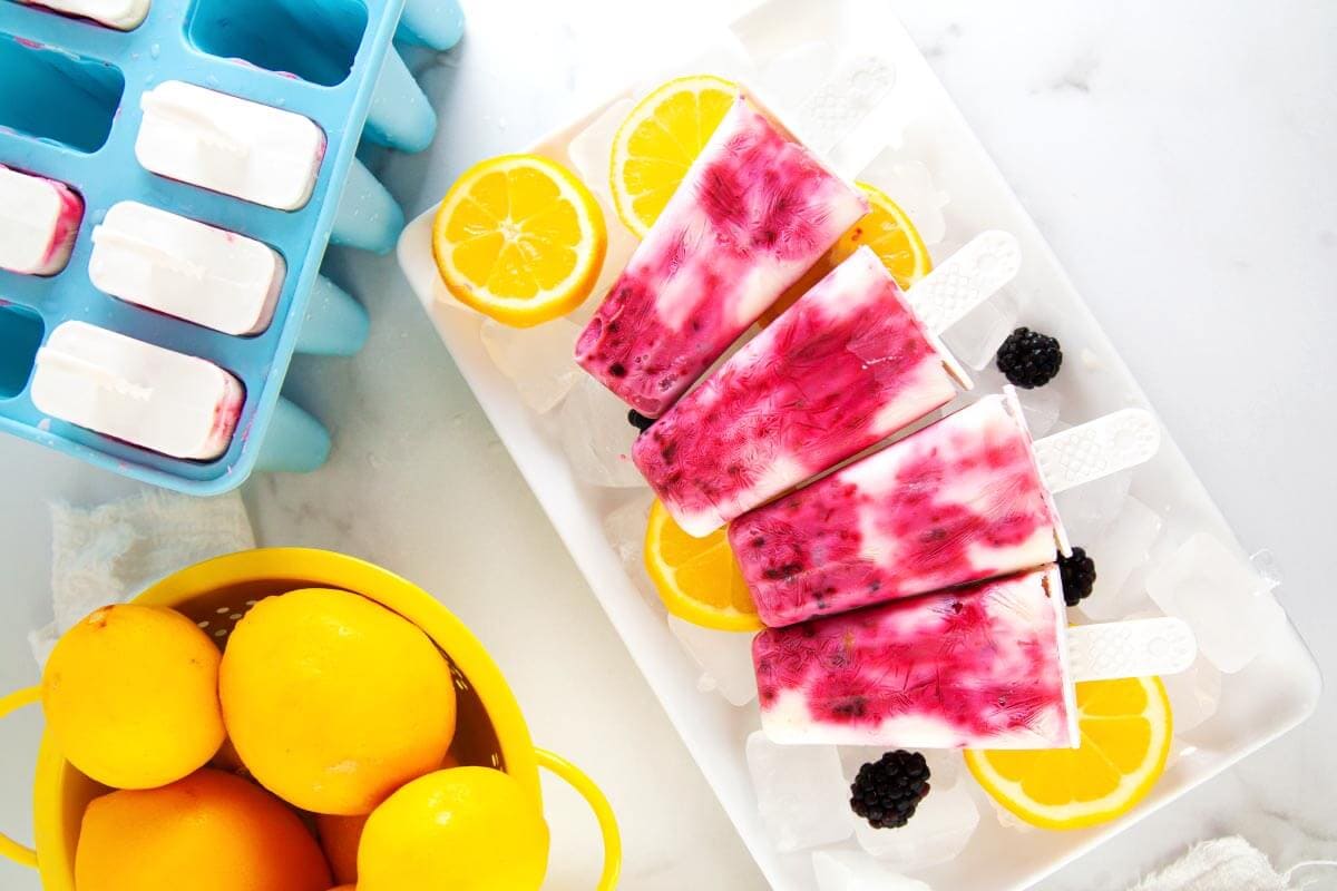 Easy Blackberry Popsicles on a white plate.