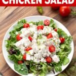 Easy Chicken Salad on greens in a white bowl.