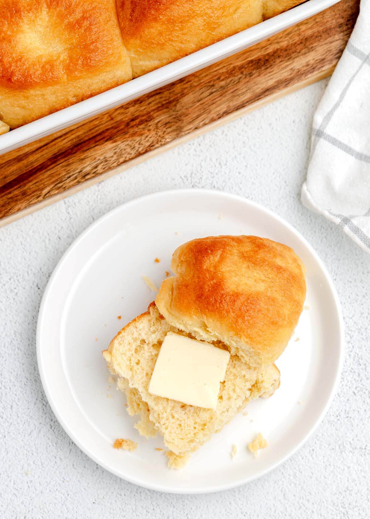 dinner roll with butter on a plate