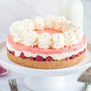 no bake layered Raspberry Cheesecake on a cake stand.