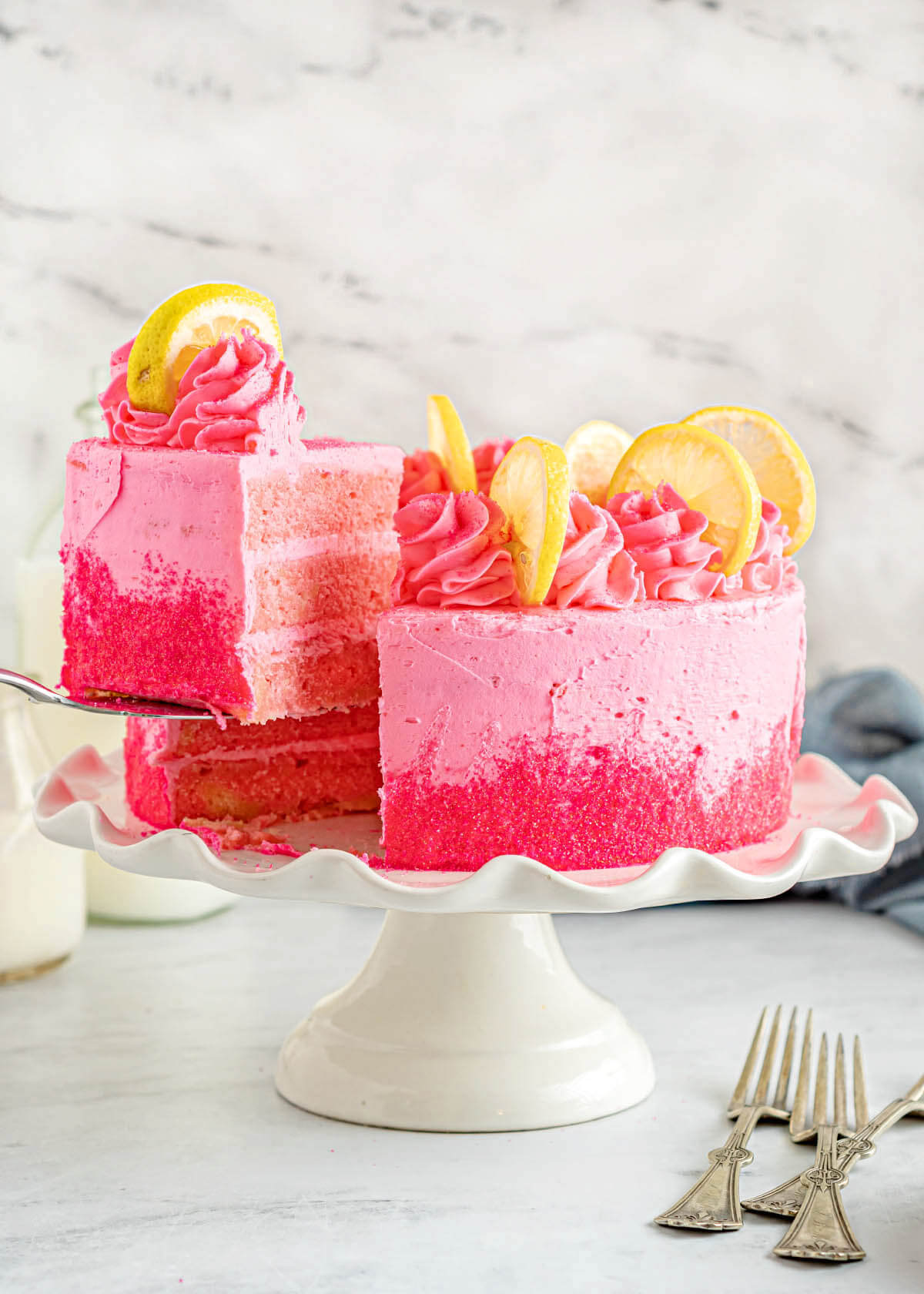 Pink Lemonade Cake with slice being lifted.