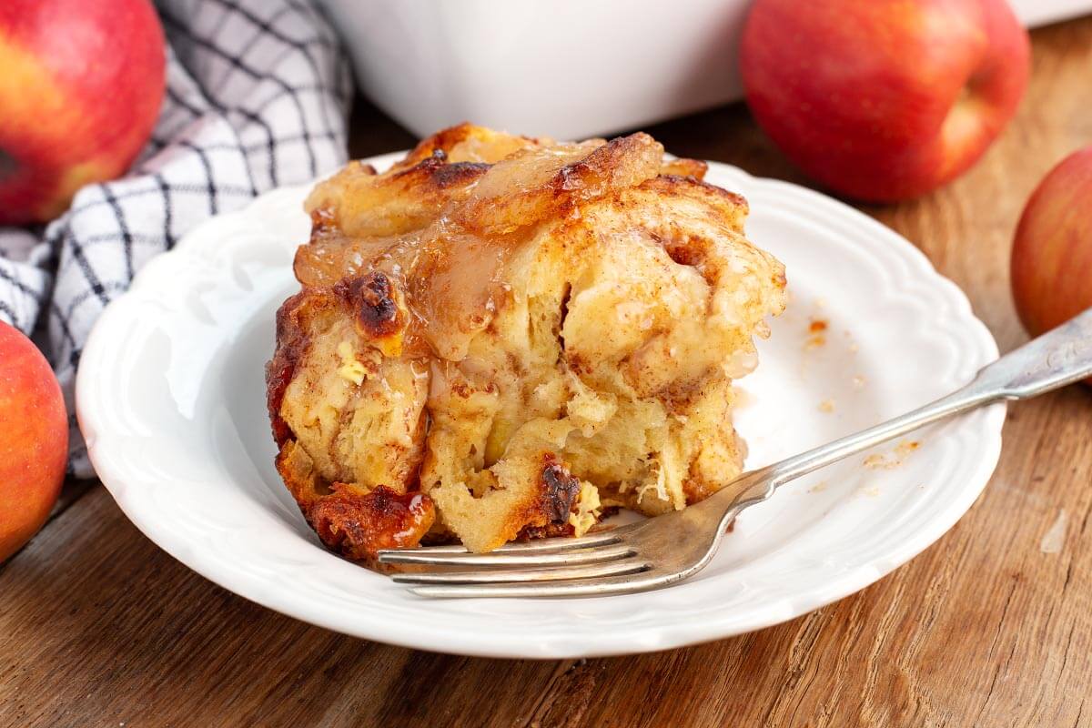 serving of apple cinnamon roll casserole on a white plate