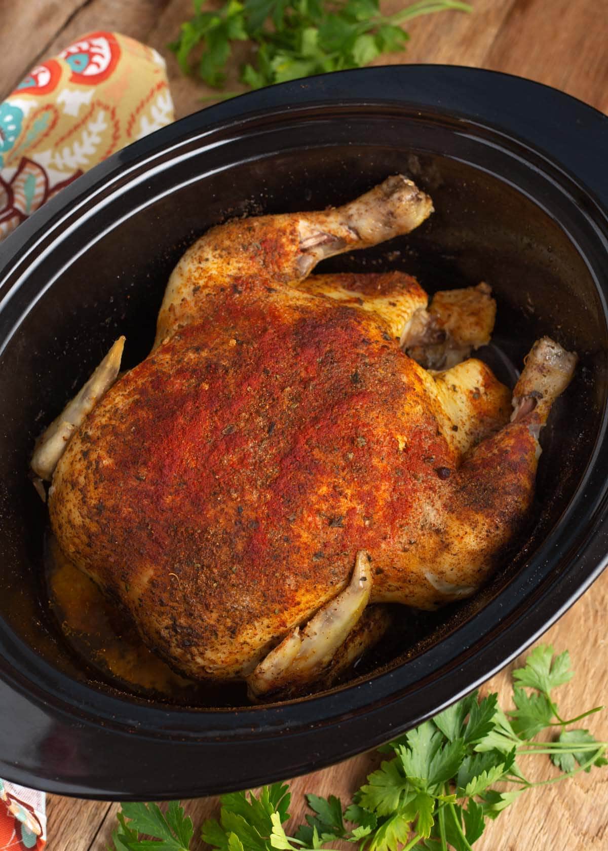 Slow Cooker Whole Chicken in a black crock