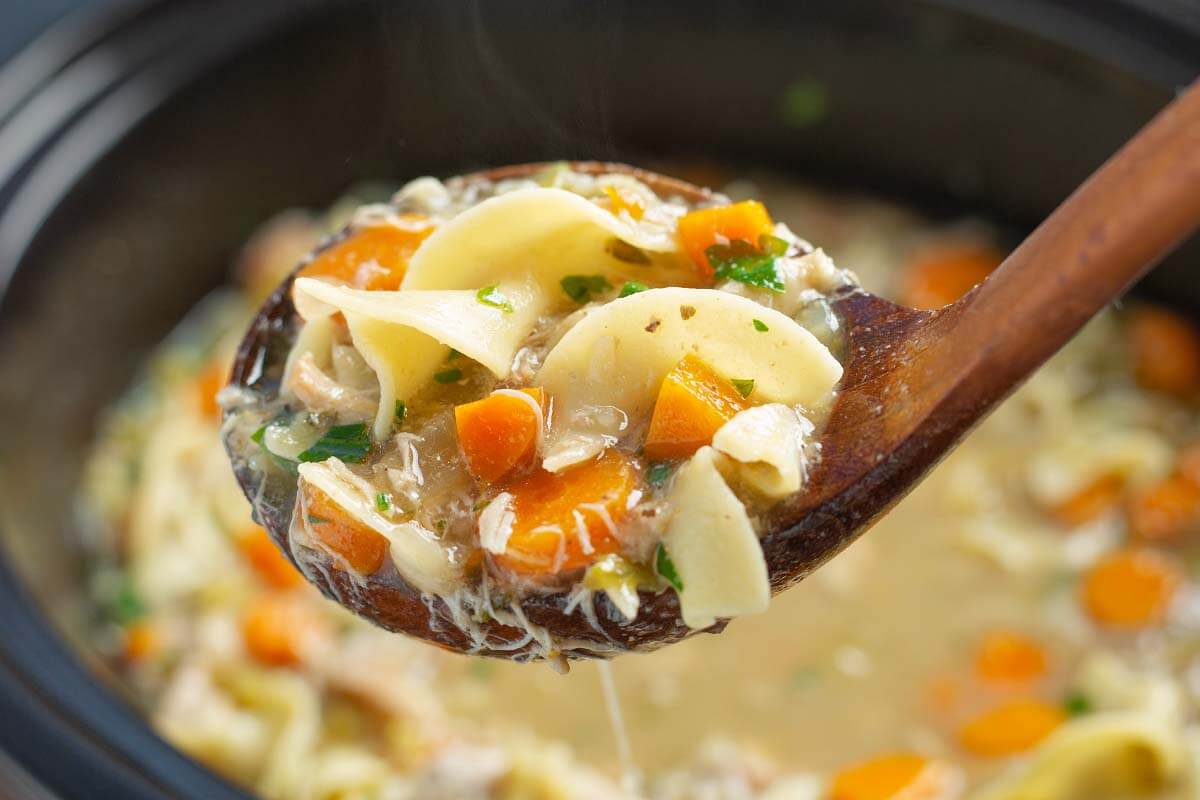Slow Cooker Chicken Noodle Soup in a wood spoon.