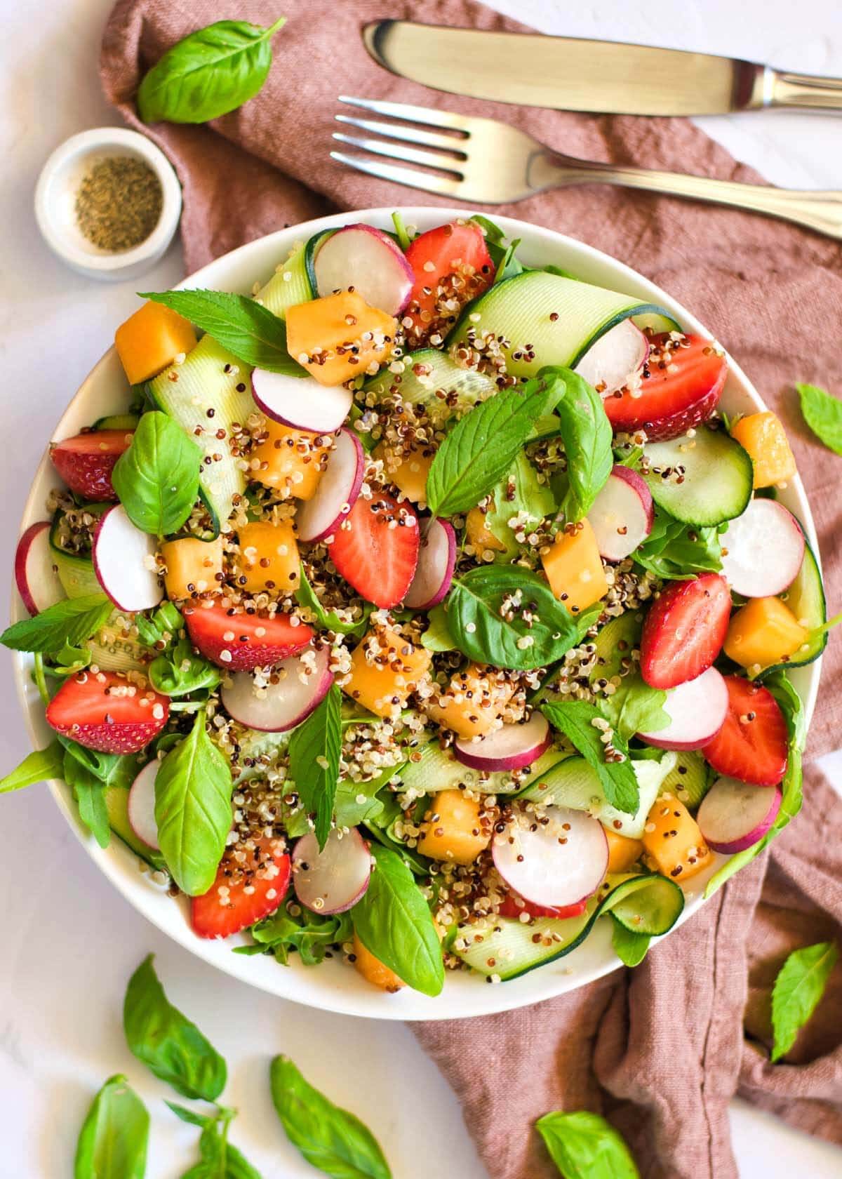 Salad with melon and strawberries in a bowl.