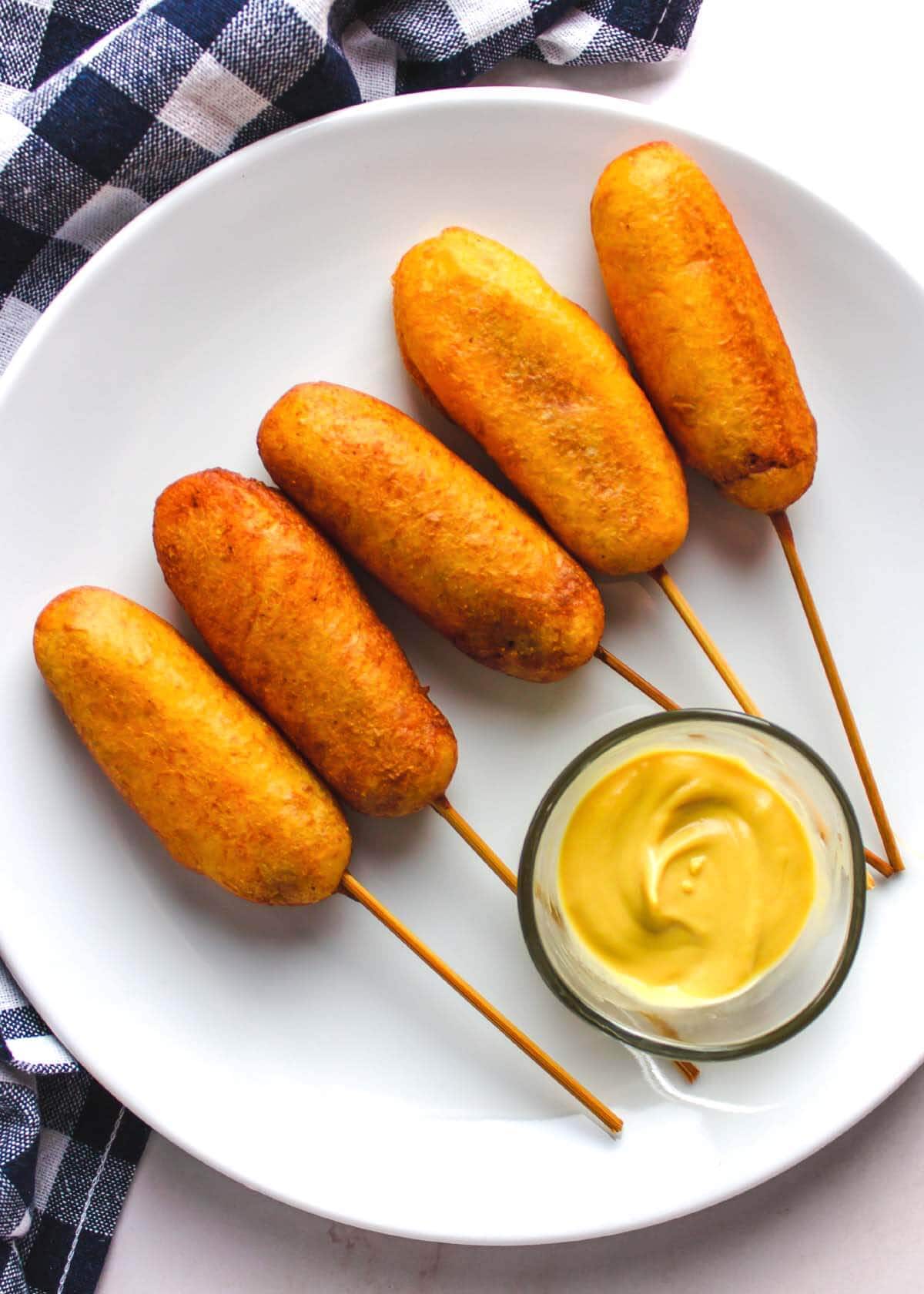Corn Dogs on a white plate.