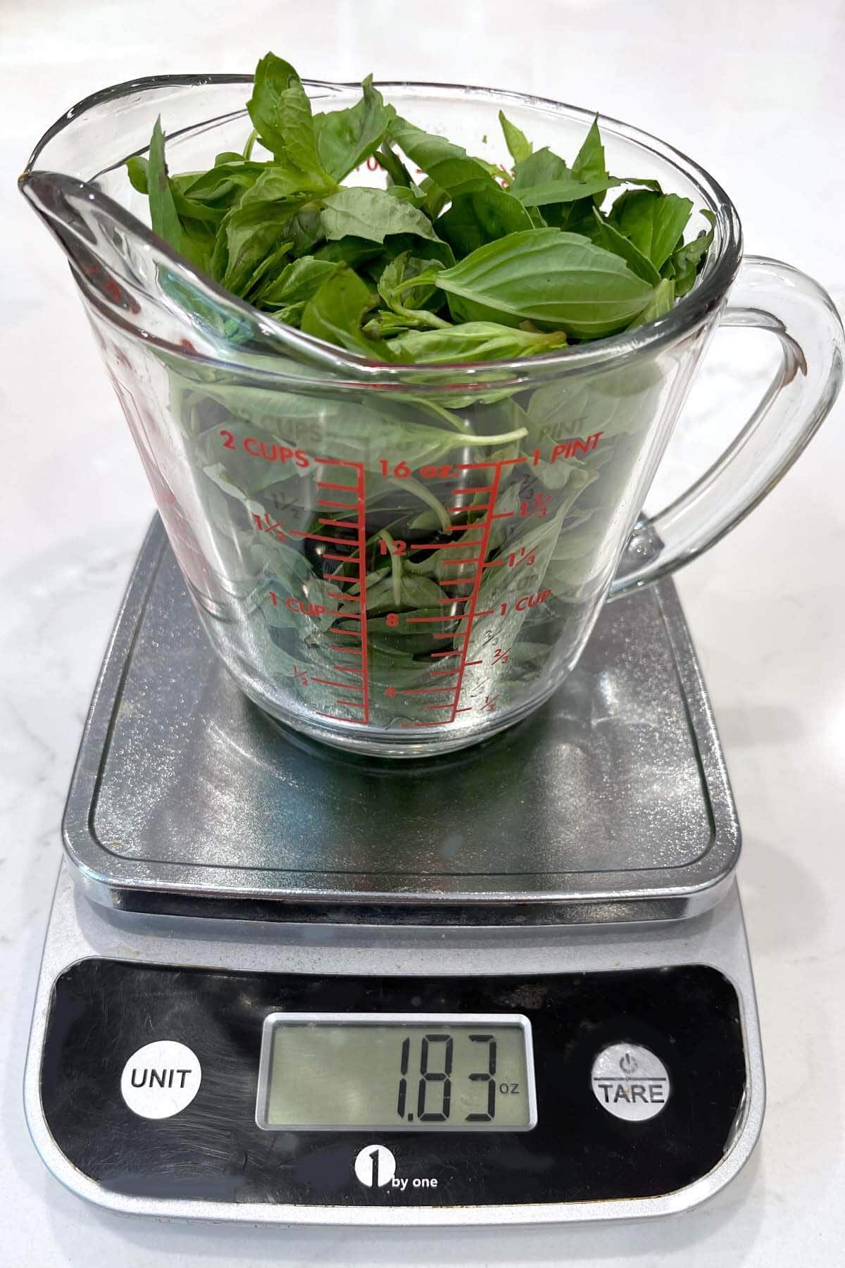 basil leaves being weighed.
