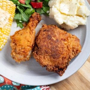 2 pieces of Fried Chicken on a plate.