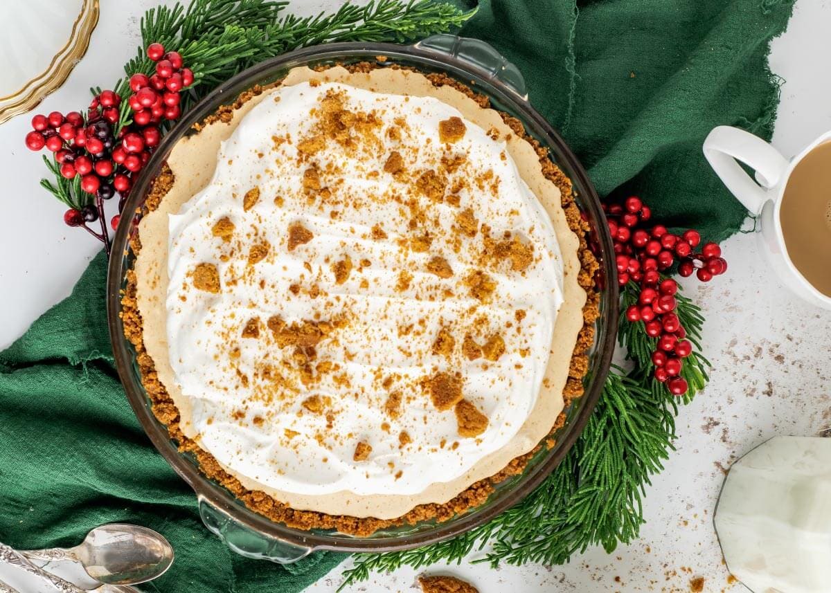 Gingerbread Cream Pie with greenery and berries decor.
