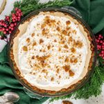 Gingerbread Cream Pie with greenery and berries decor.