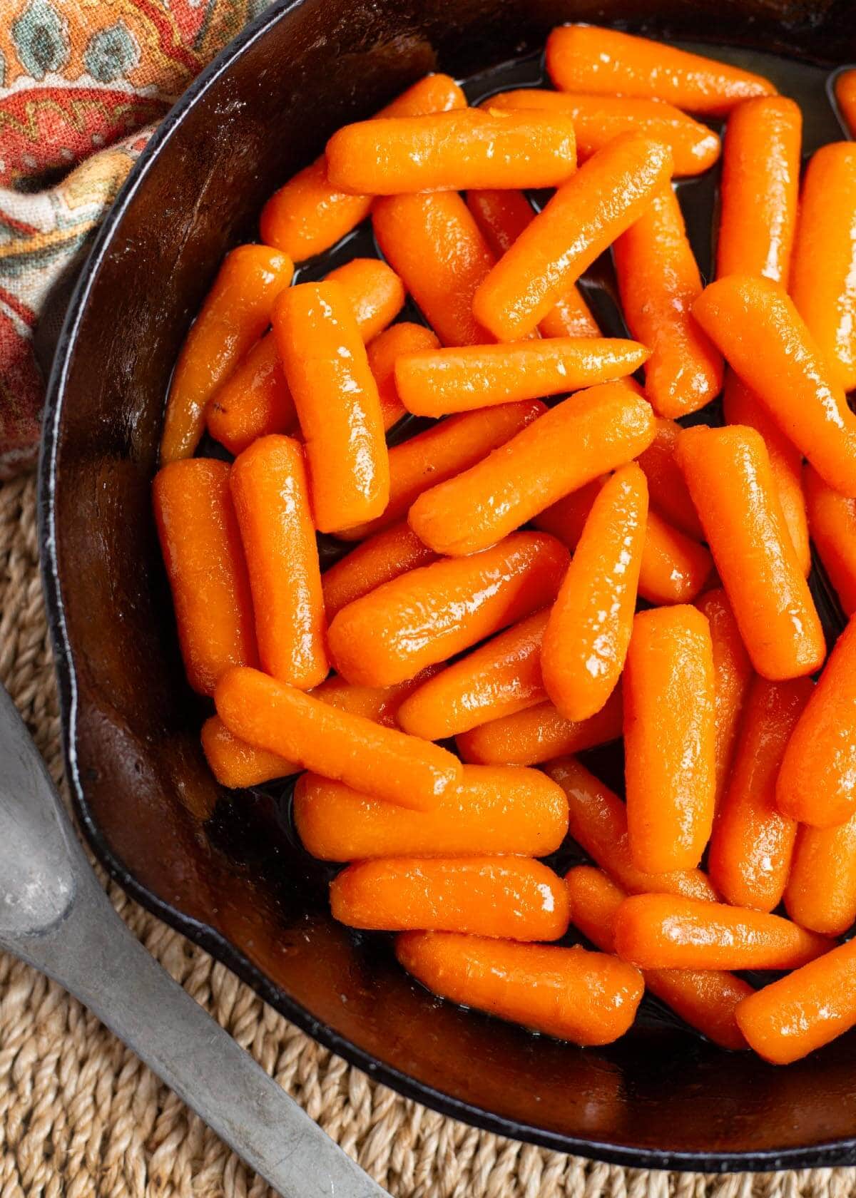 Brown Sugar Glazed Carrots in a black skillet