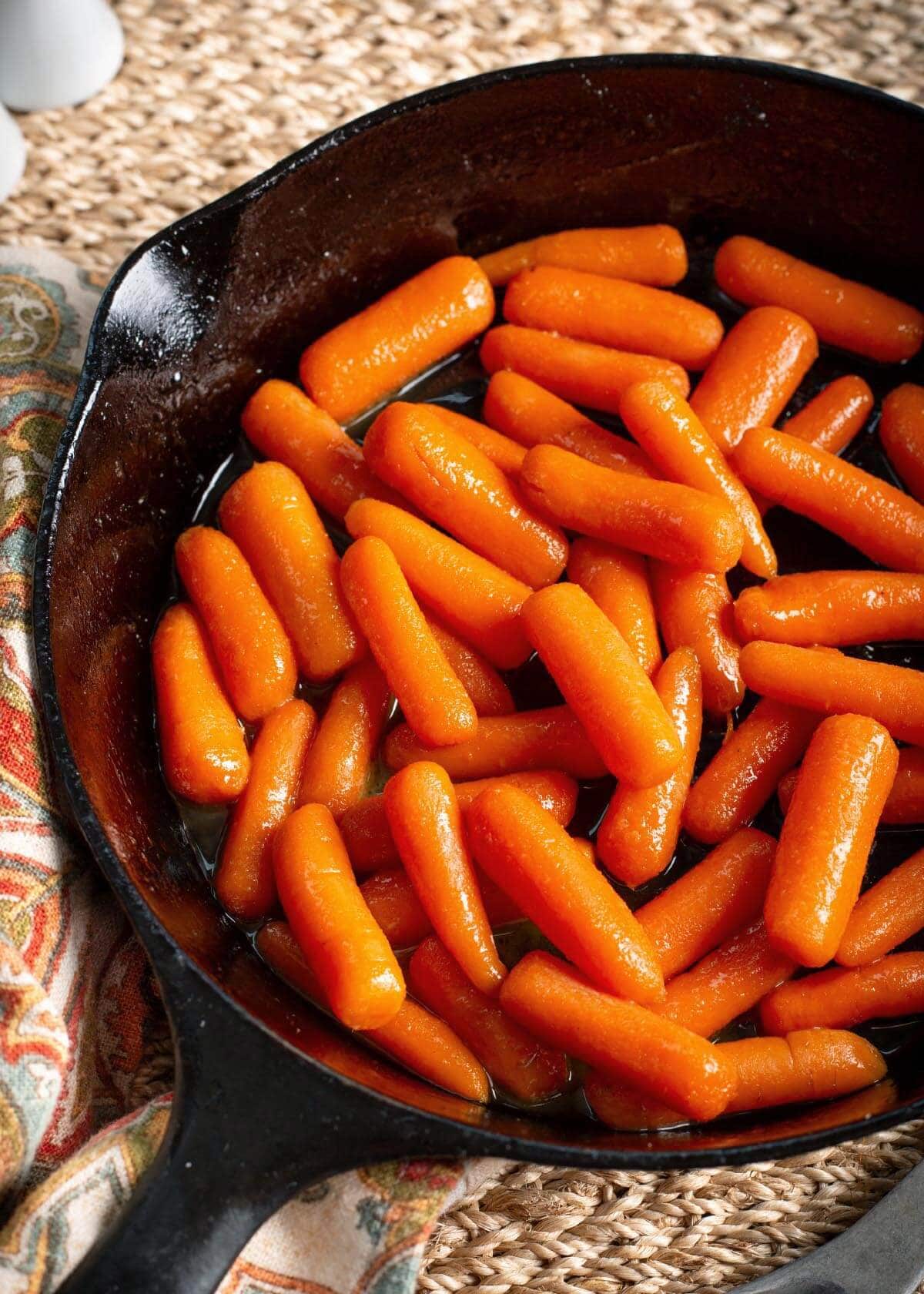 black skillet with carrots in it.