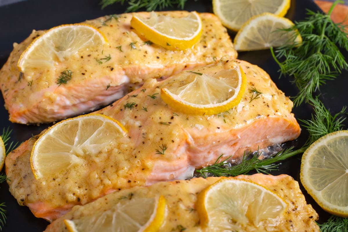 Baked Dijon Salmon Filets on a black plate