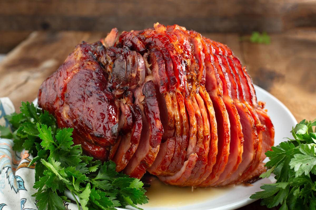 Brown Sugar Glazed Spiral Ham on a white plate