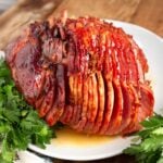 Brown Sugar Glazed Spiral Ham on a white plate