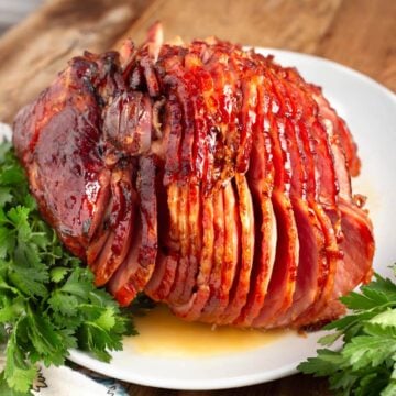 Brown Sugar Glazed Spiral Ham on a white plate