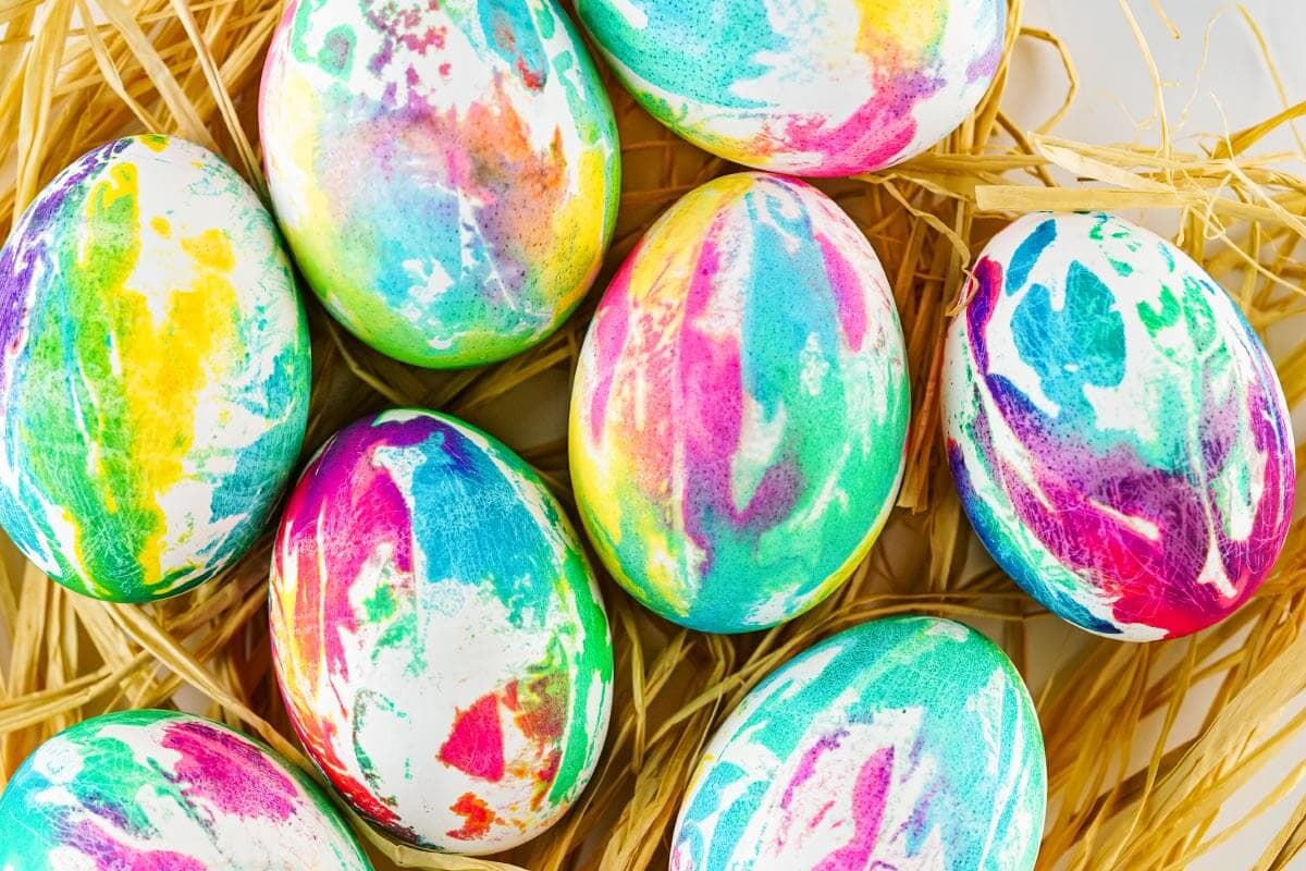 tie dyed easter eggs on straw.